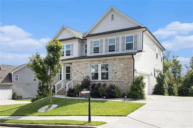 a view of a yard in front view of a house