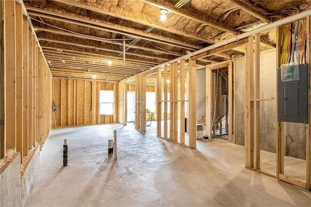 a view of the room with wooden floor and windows