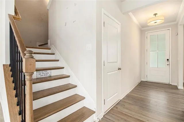 a view of a hallway with wooden floor and entryway