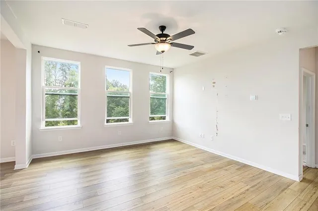 wooden floor in an empty room with a window