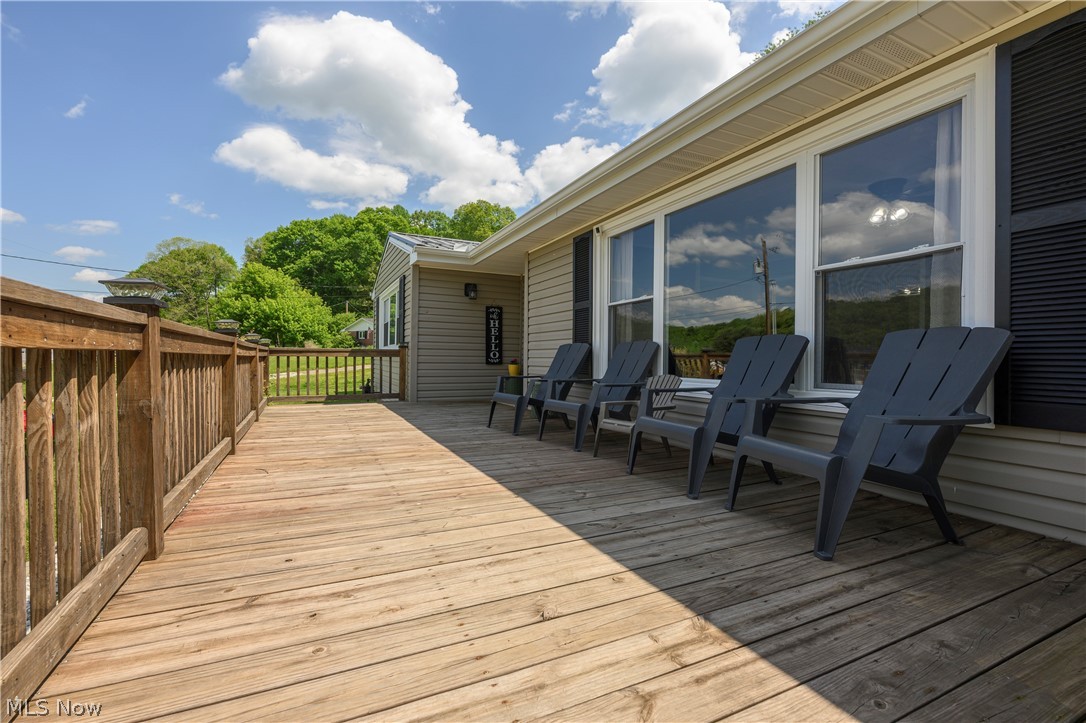 6105 Wolf Run Road Southeast Dennison, OH 44621 - Photo 4 of 35 Expansive wood deck with a full-height railing