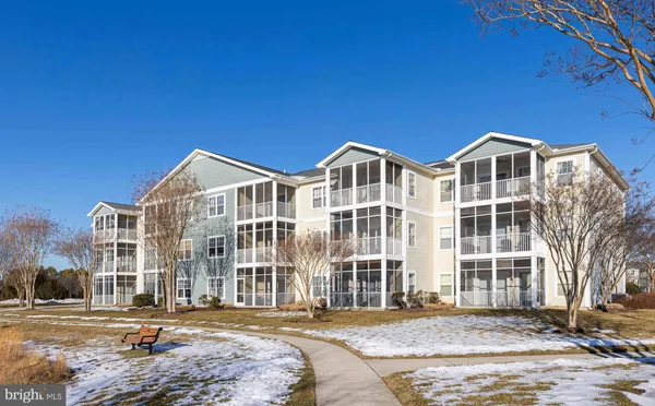 a front view of a building with a garden