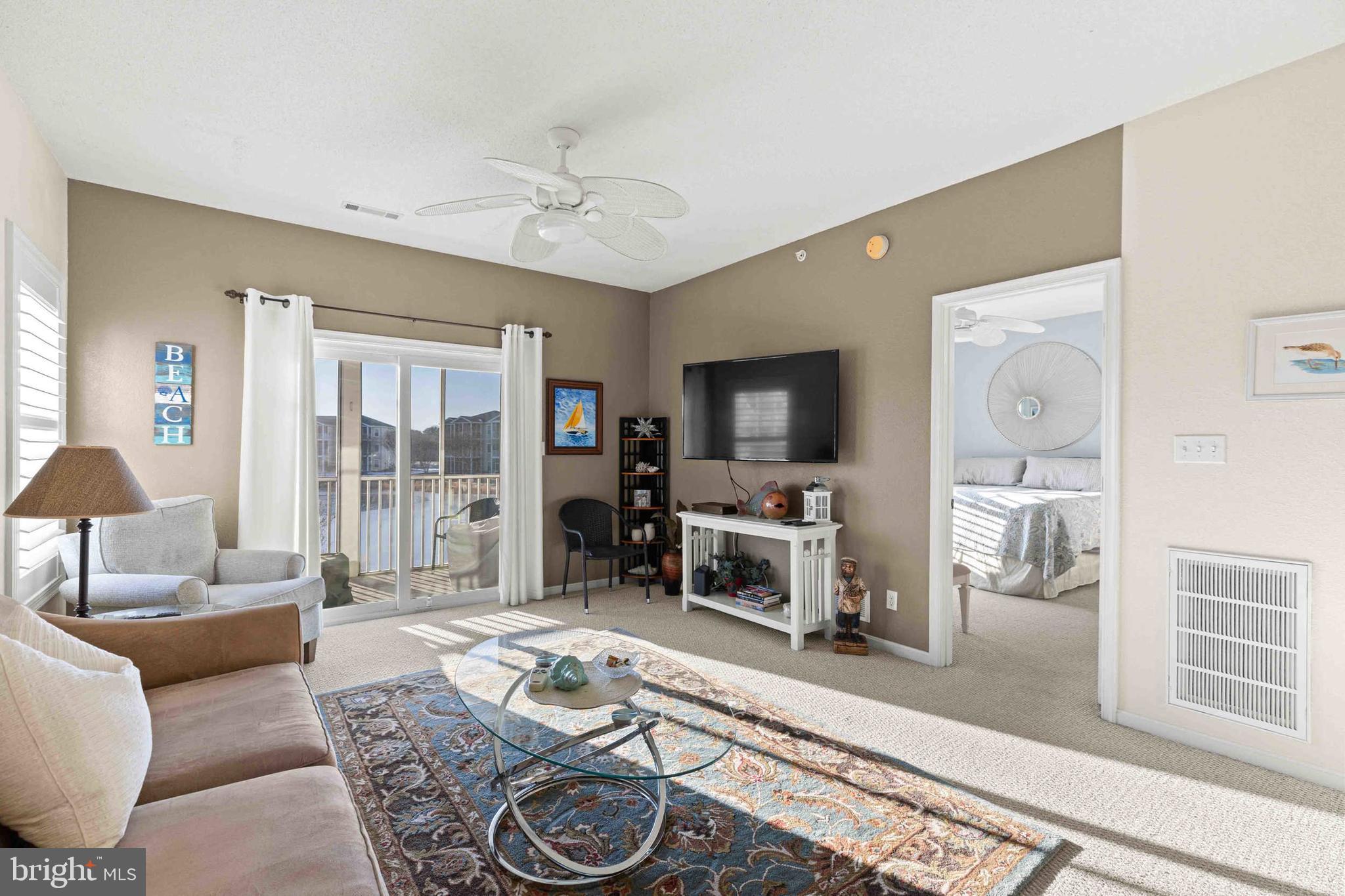 33192 North Village Loop, Unit 5202 Lewes, DE 19958 - Photo 19 of 42 Living room with bedroom and balcony
