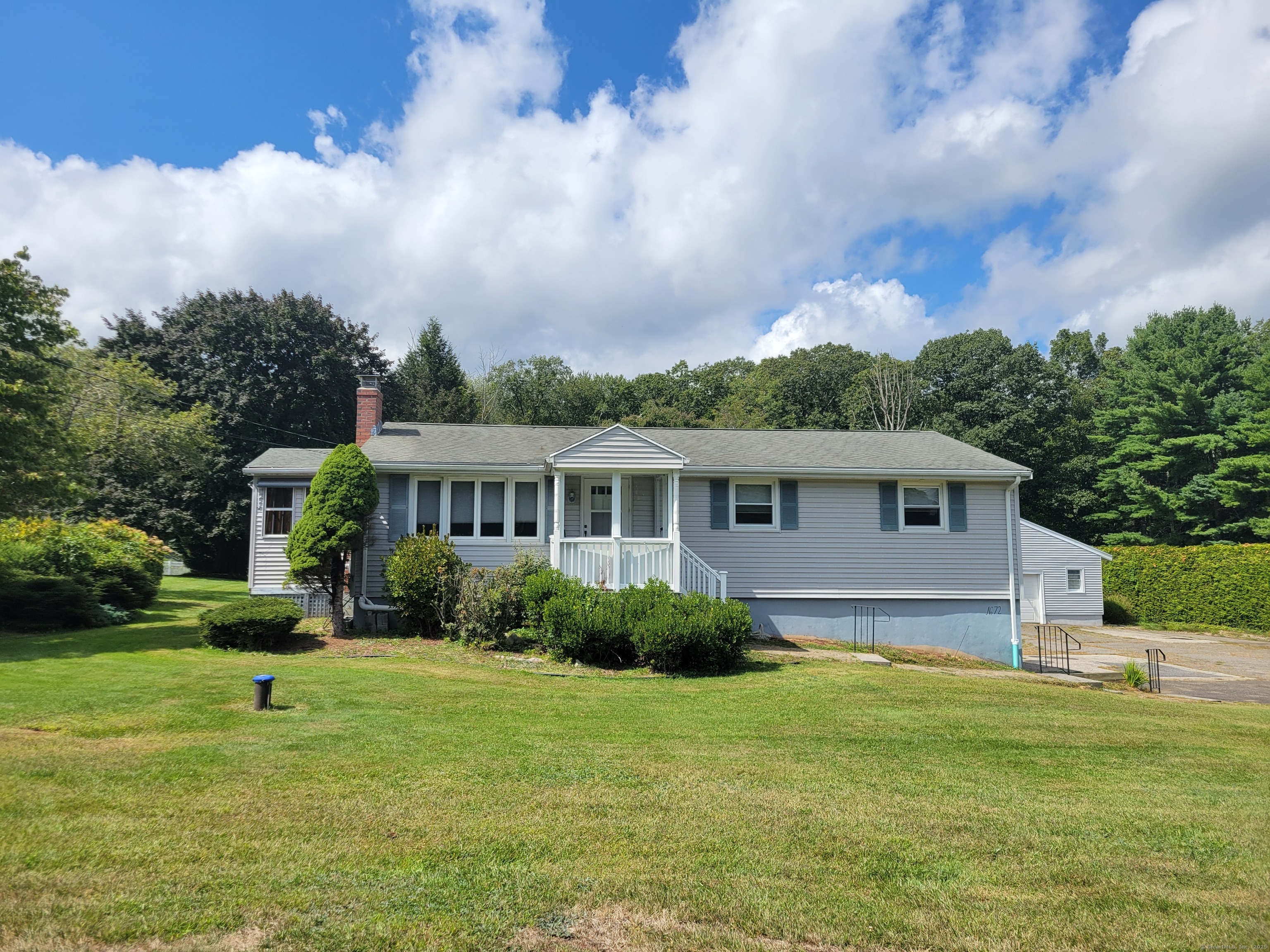 a front view of a house with a garden