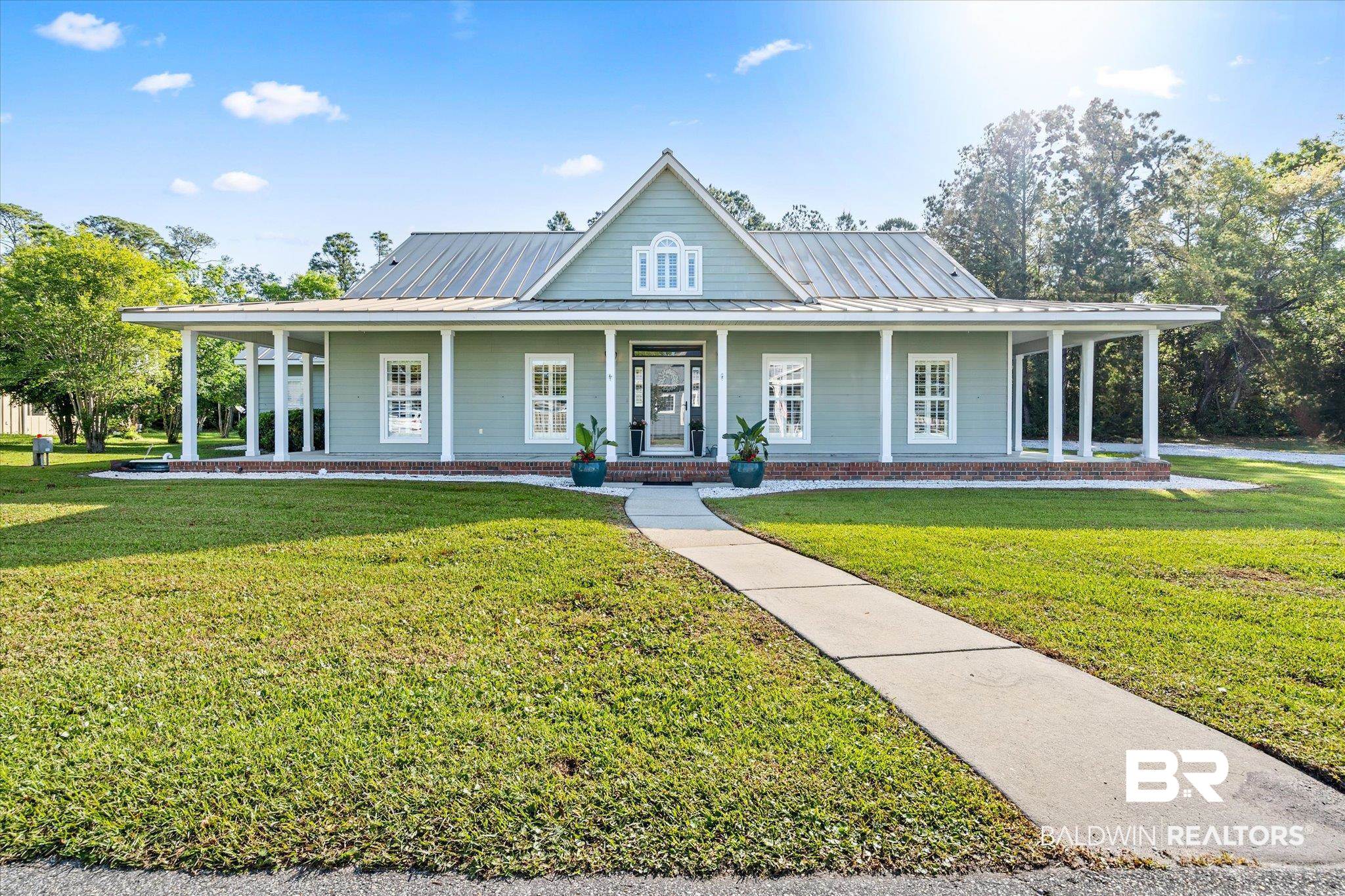 4947 Look Rook Road Orange Beach, AL 36561 - Photo 22 of 24 Farmhouse featuring a front yard, a porch, metal roof, and a standing seam roof