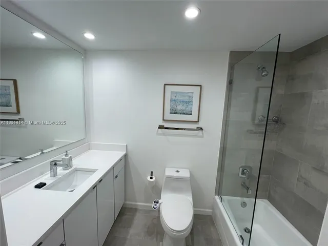 a bathroom with a toilet sink shower and mirror