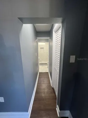 a view of a hallway with wooden floor