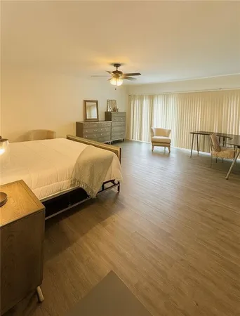 a spacious bedroom with a bed and large windows