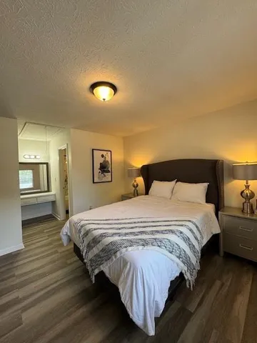 a bedroom with a bed and a night stand