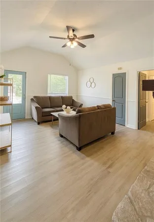 a living room with furniture and a ceiling fan