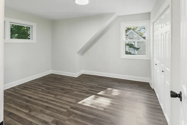 a view of a room with wooden floor and window