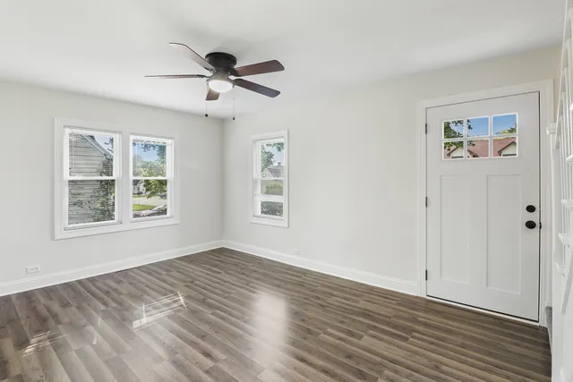 wooden floor in an empty room with a window