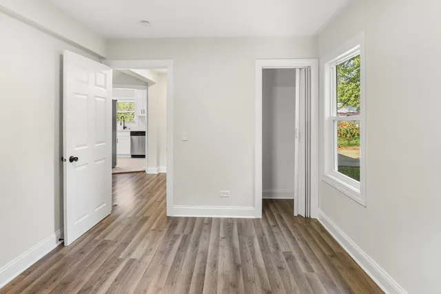 a view of hallway with wooden floor