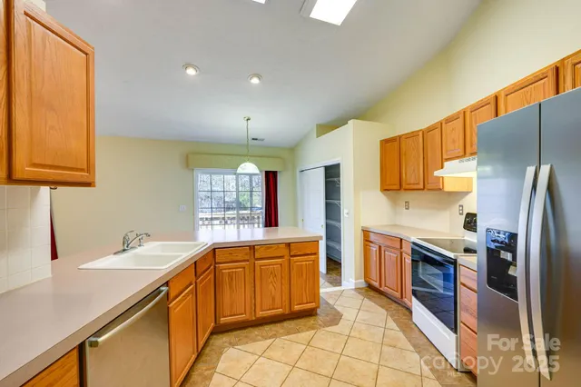 a view of an empty room with a fireplace and a workspace