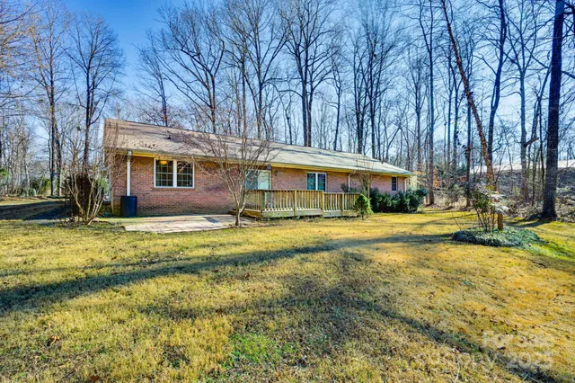 a view of a house with swimming pool and sitting area