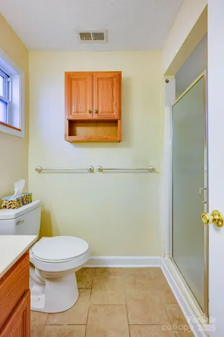 an empty room with a ceiling fan and a window