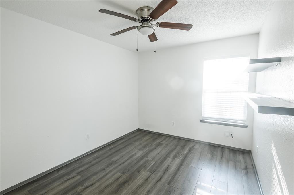 7324 Hyde Court Fort Worth, TX 76112 - Photo 14 of 20 an empty room with a window and a ceiling fan