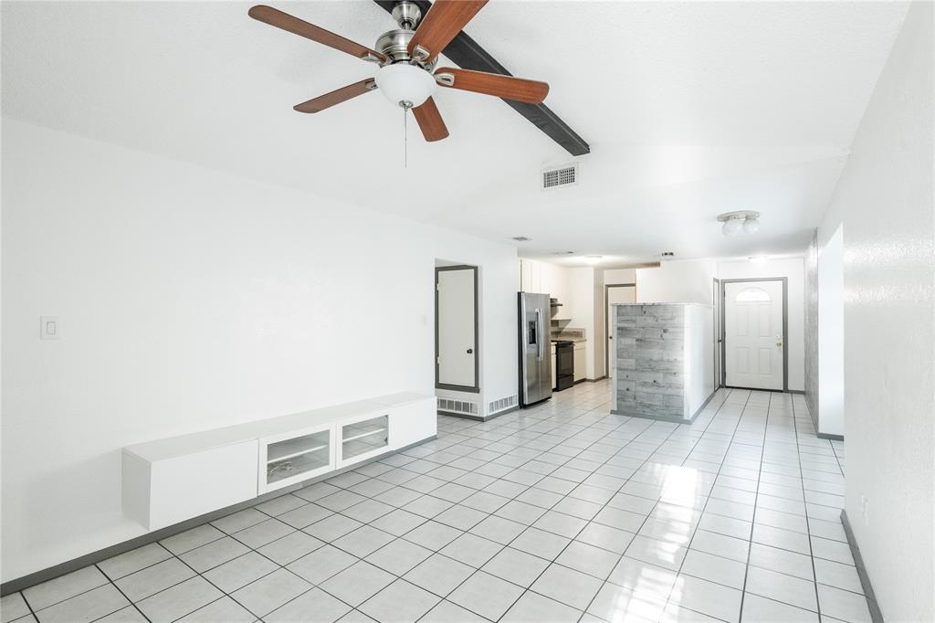 7324 Hyde Court Fort Worth, TX 76112 - Photo 16 of 20 a view of a livingroom with a ceiling fan and staircase
