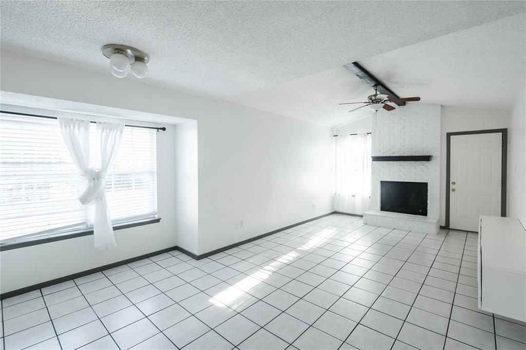 7324 Hyde Court Fort Worth, TX 76112 - Photo 17 of 20 a view of empty room with window and fireplace