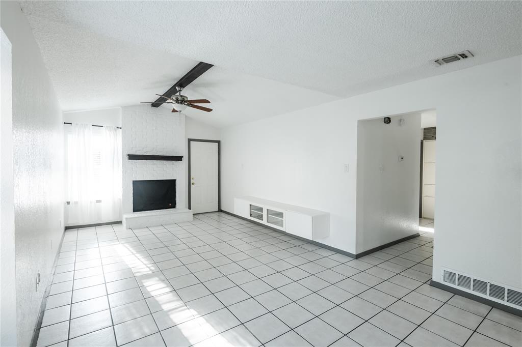 7324 Hyde Court Fort Worth, TX 76112 - Photo 18 of 20 an empty room with windows and fireplace