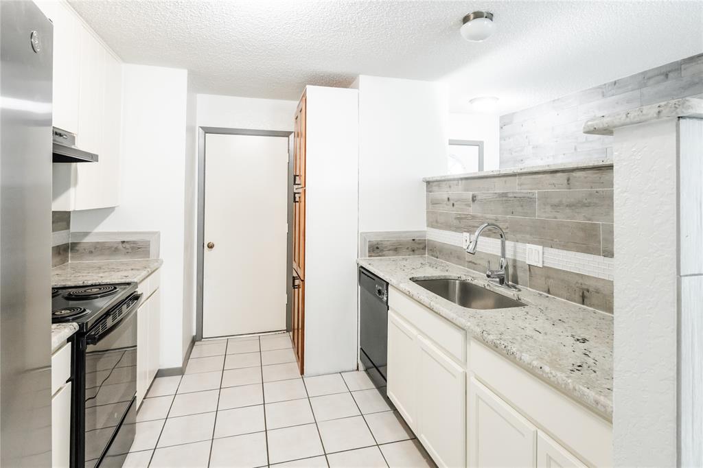 7324 Hyde Court Fort Worth, TX 76112 - Photo 8 of 20 a kitchen with a sink stove top oven and refrigerator