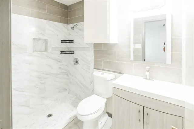 a bathroom with a sink toilet and shower