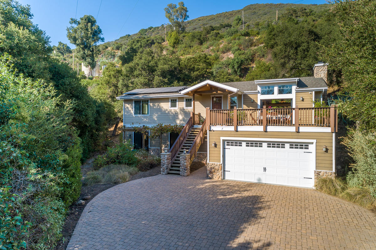 7 North San Marcos Road Santa Barbara, CA 93111 - Photo 2 of 43 a front view of a house with a yard and garage