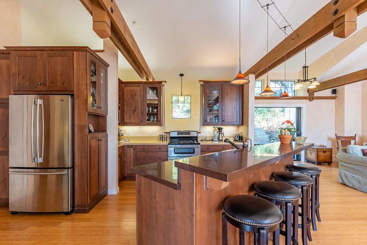 7 North San Marcos Road Santa Barbara, CA 93111 - Photo 5 of 43 a kitchen with stainless steel appliances granite countertop a refrigerator a stove a sink dishwasher and a refrigerator with wooden floor