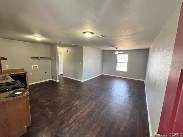 a view of livingroom with hardwood floor and a ceiling fan