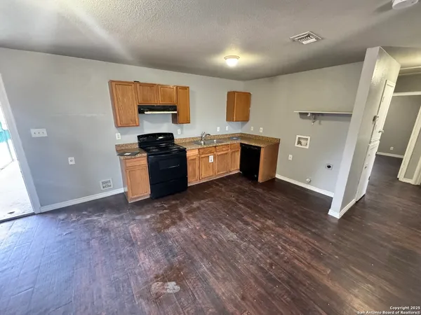 a kitchen with stainless steel appliances granite countertop a stove and a refrigerator