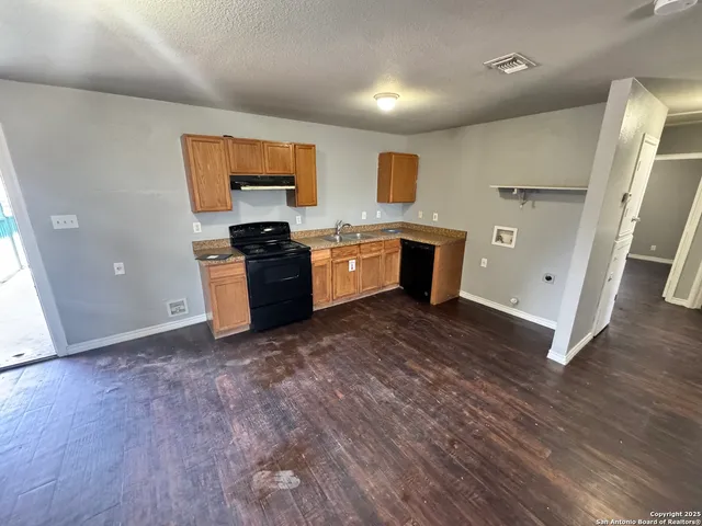 a kitchen with stainless steel appliances granite countertop a stove and a refrigerator