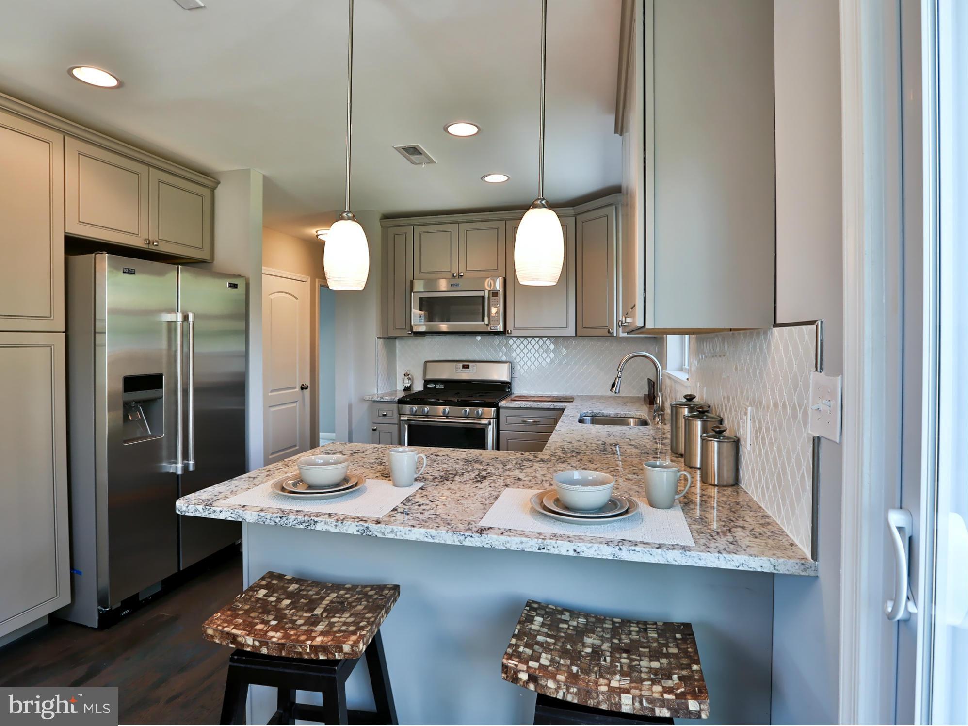 3422 Kimble Road Baltimore, MD 21244 - Photo 7 of 30 Kitchen With Granite Countertops & Breakfast Bar