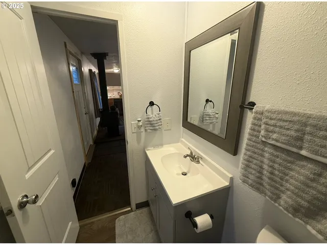 a bathroom with a sink a toilet a mirror and shower