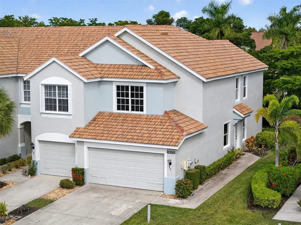 a view of a white house next to a yard