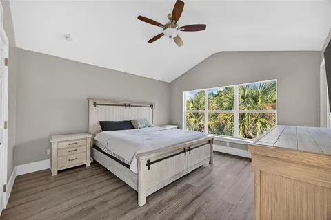 a living room with a bed and a large window