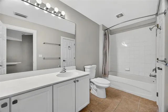 a bathroom with a double vanity sink toilet and shower