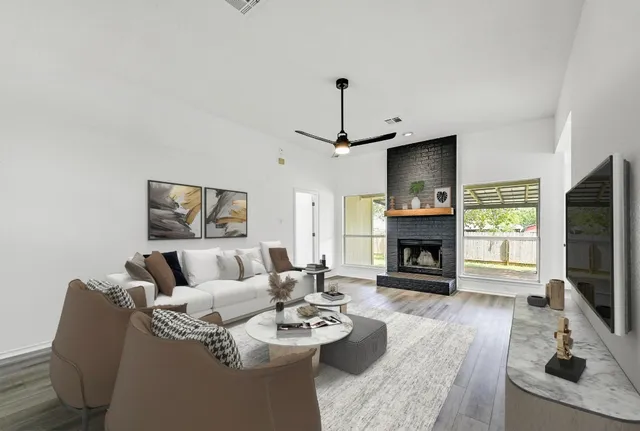 a living room with furniture a fireplace and a flat screen tv