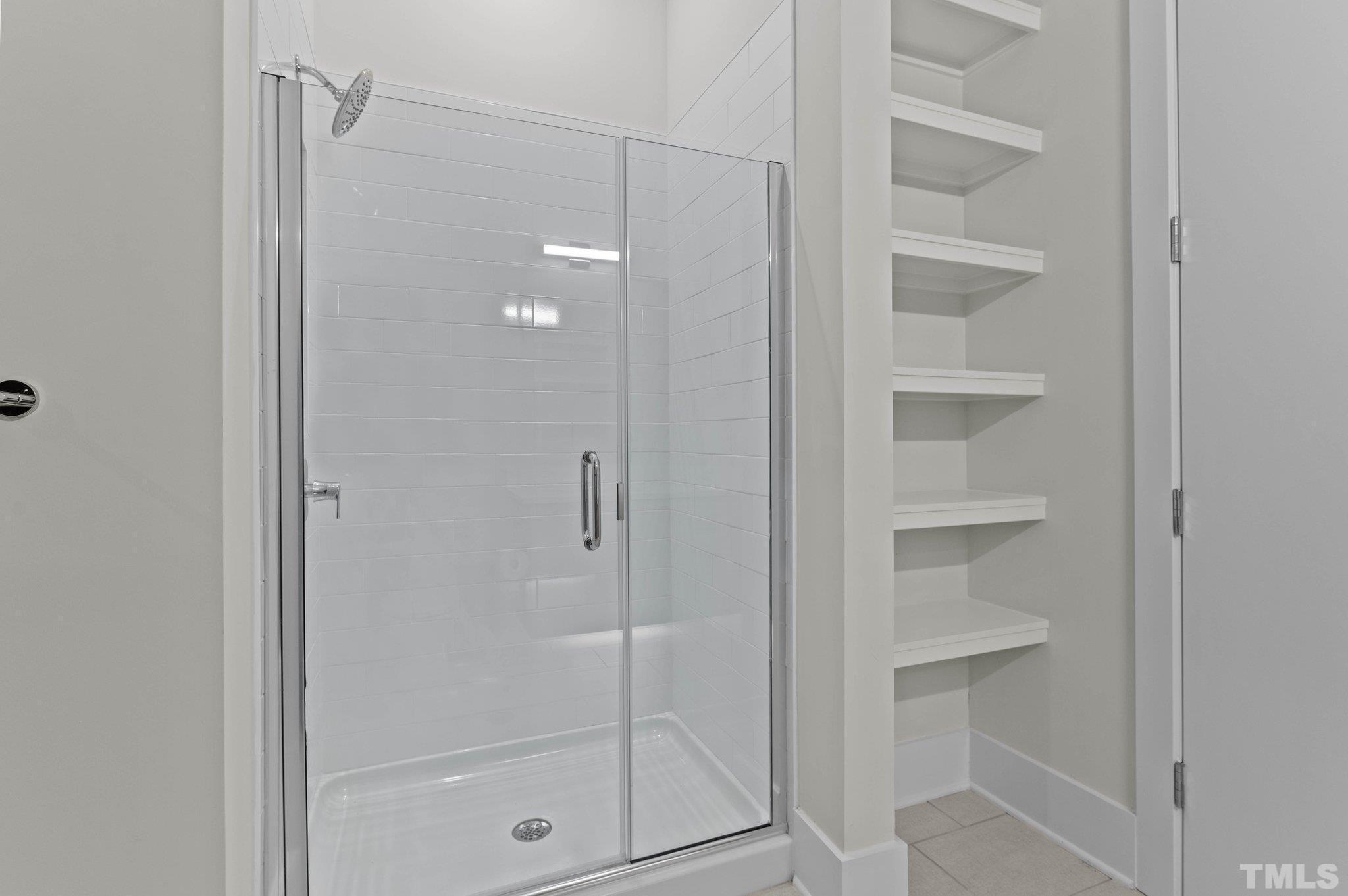 2441 Campus Shore Drive, Unit 309 Raleigh, NC 27606 - Photo 17 of 49 a bathroom with a glass shower door
