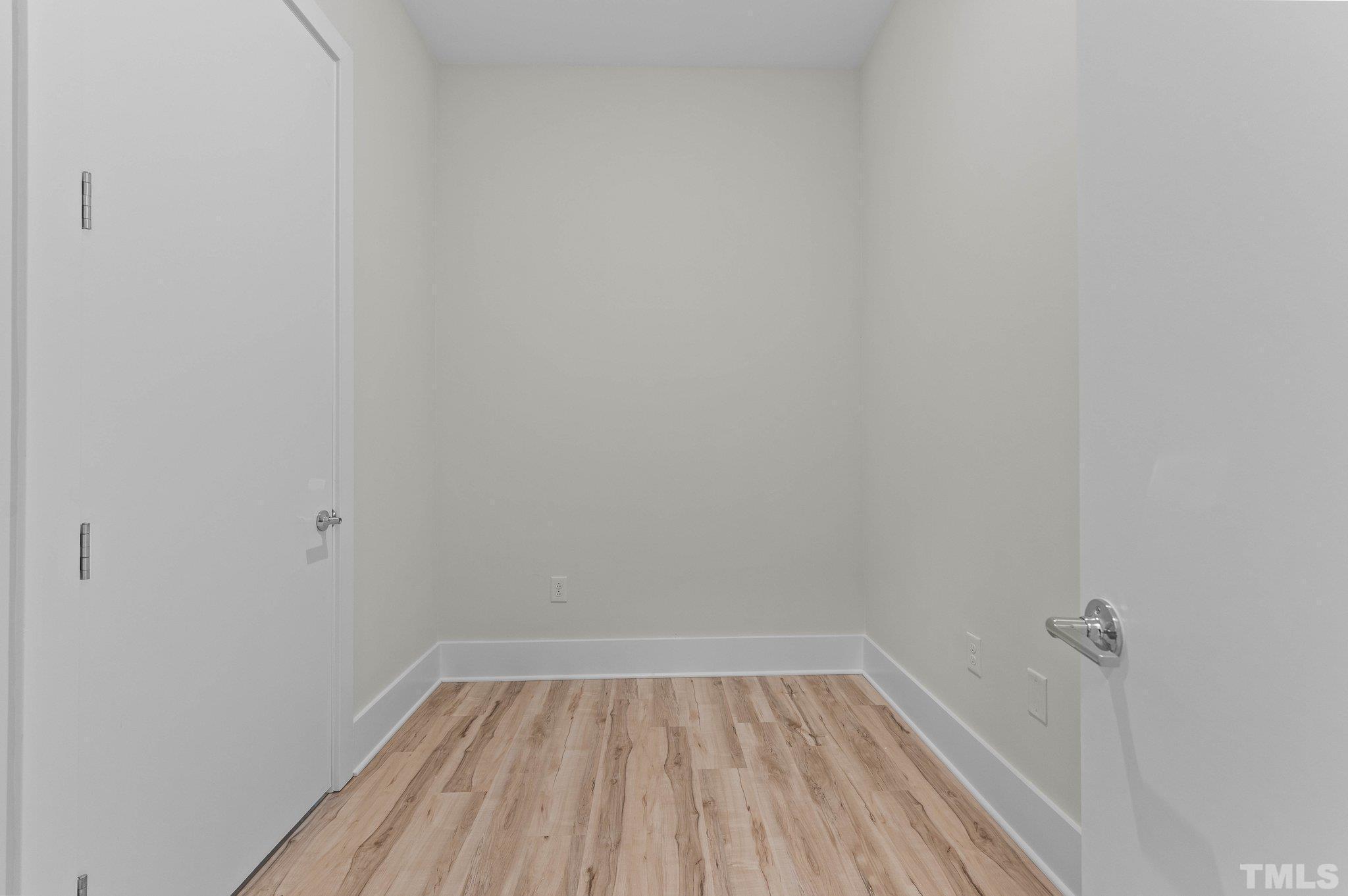 2441 Campus Shore Drive, Unit 309 Raleigh, NC 27606 - Photo 19 of 49 a view of a small space with wooden floor and a window