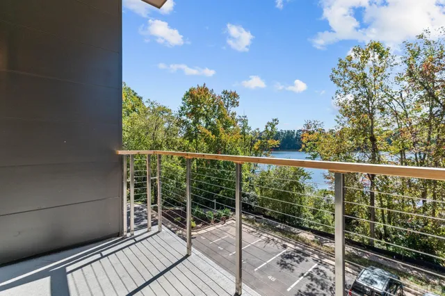 a view of balcony with wooden floor and fence