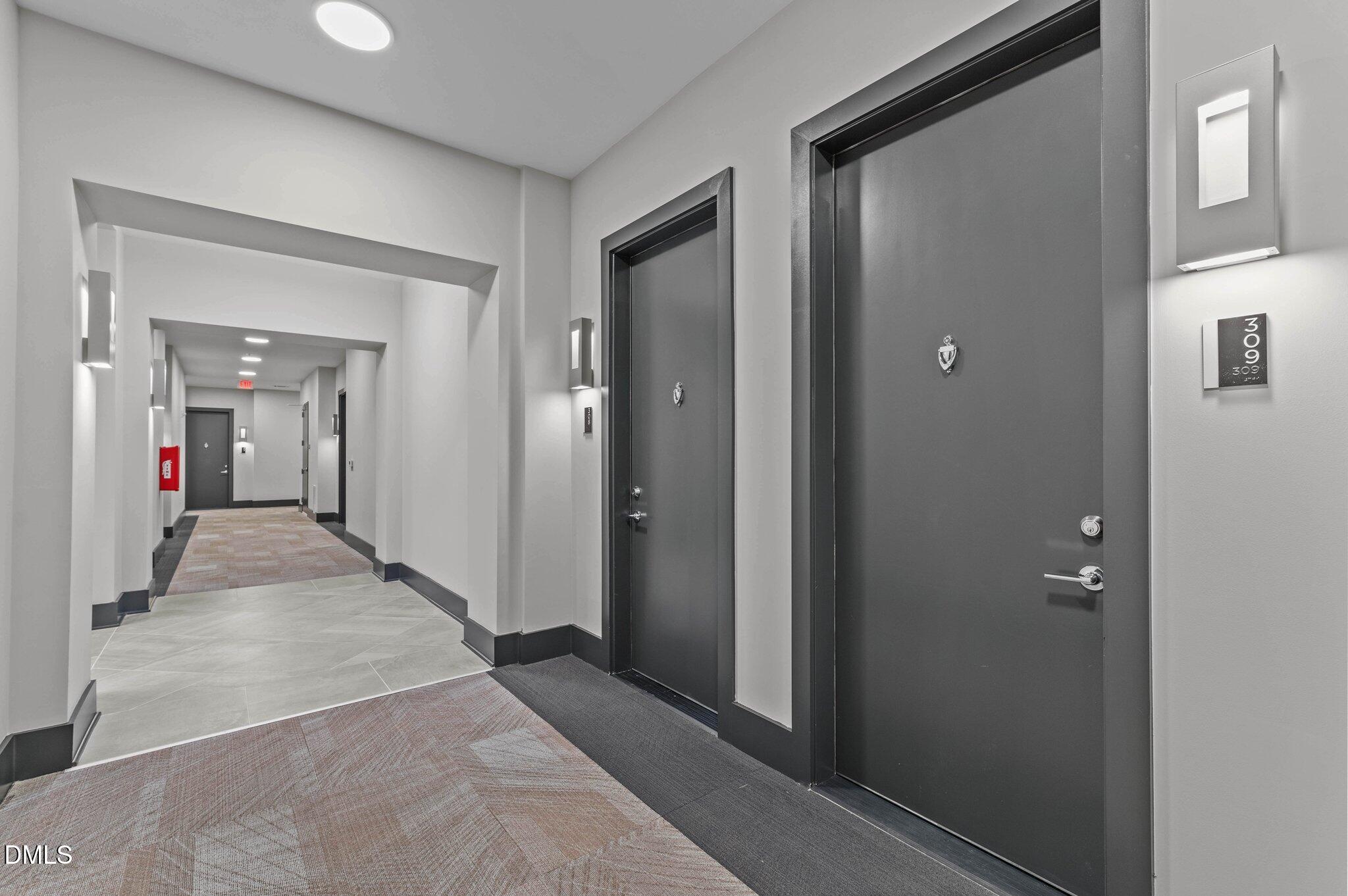 2441 Campus Shore Drive, Unit 309 Raleigh, NC 27606 - Photo 23 of 49 a view of a hallway with wooden shelves