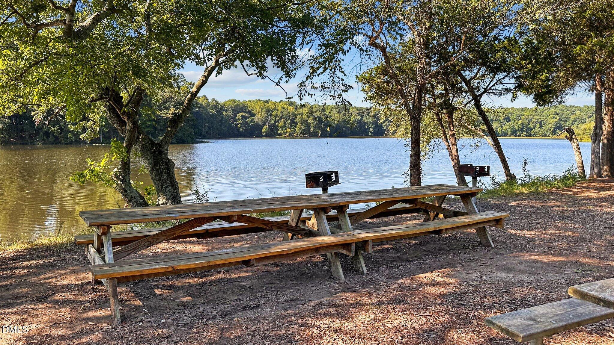 2441 Campus Shore Drive, Unit 309 Raleigh, NC 27606 - Photo 35 of 49 a view of a wooden bench sitting in backyard of a house