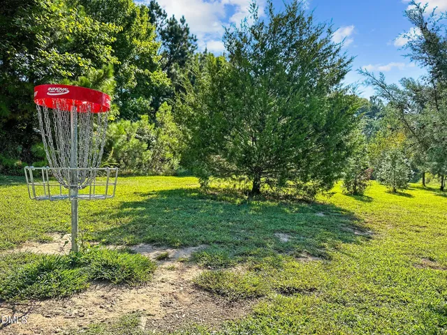 a front view of a house with a yard and lake view