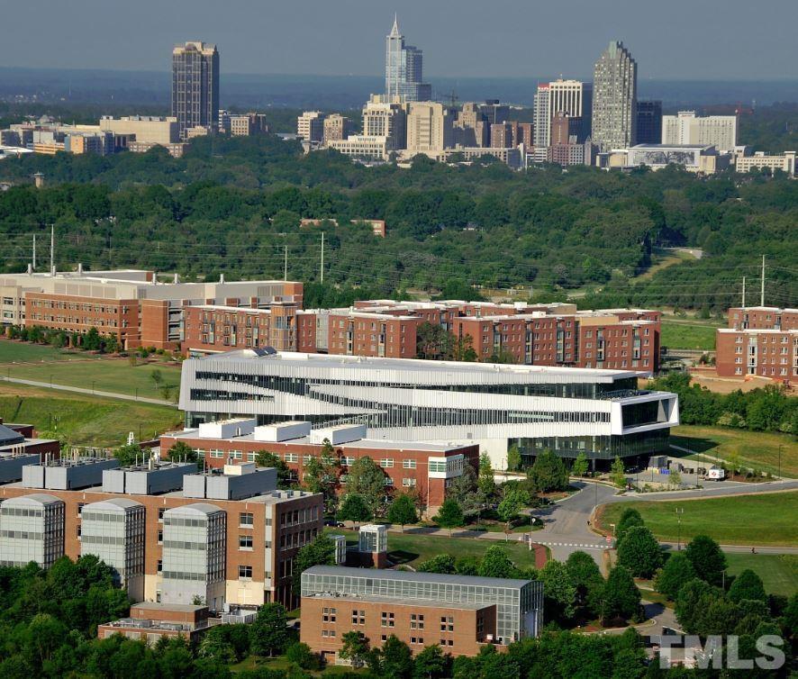 2441 Campus Shore Drive, Unit 309 Raleigh, NC 27606 - Photo 40 of 49 a front view of a house with a yard and lake view