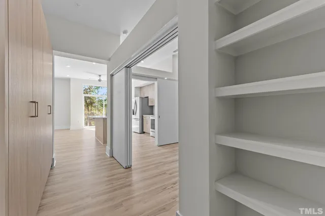 a view of a hallway with wooden floor