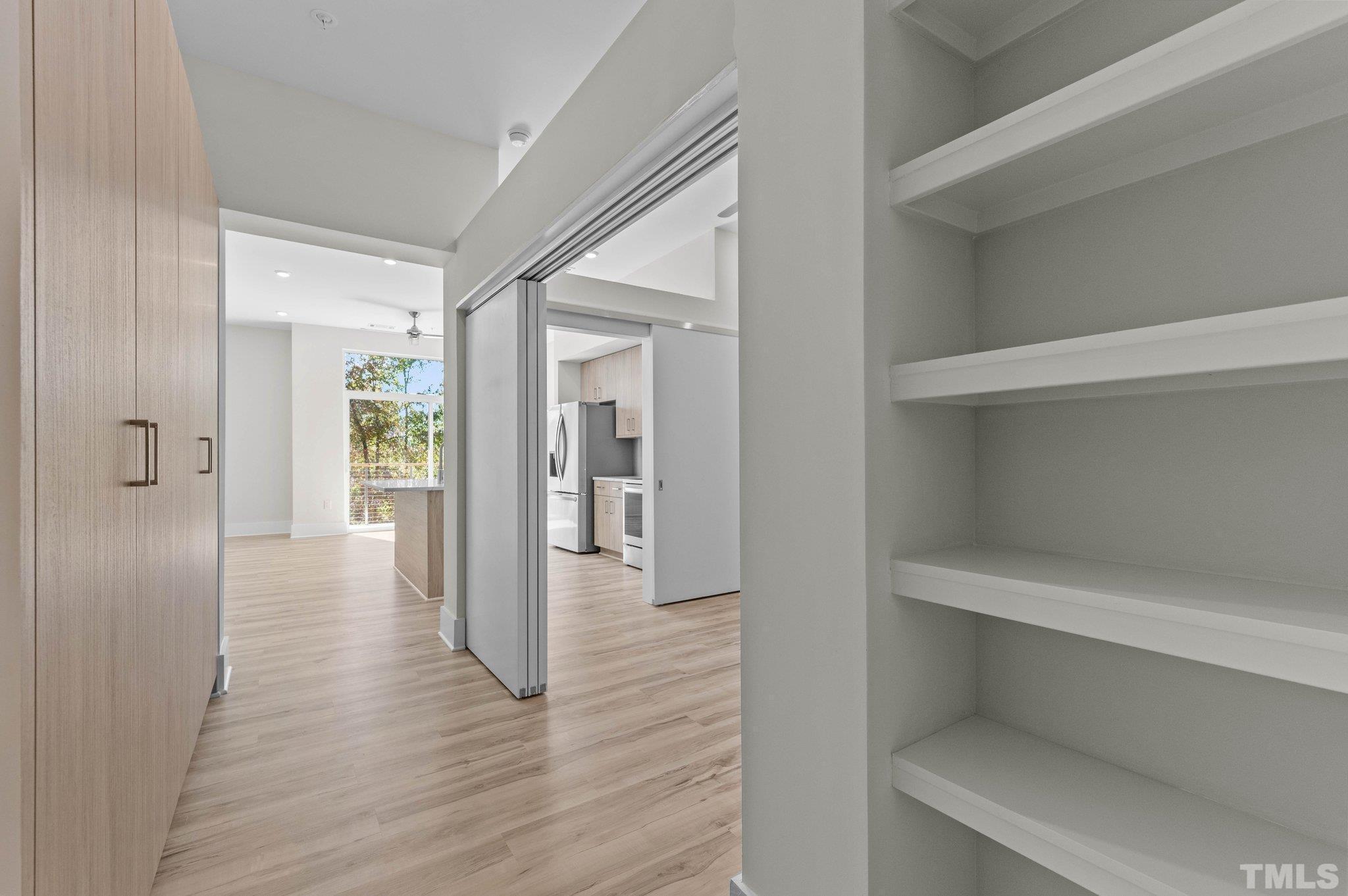 2441 Campus Shore Drive, Unit 309 Raleigh, NC 27606 - Photo 4 of 49 a view of a hallway with wooden floor