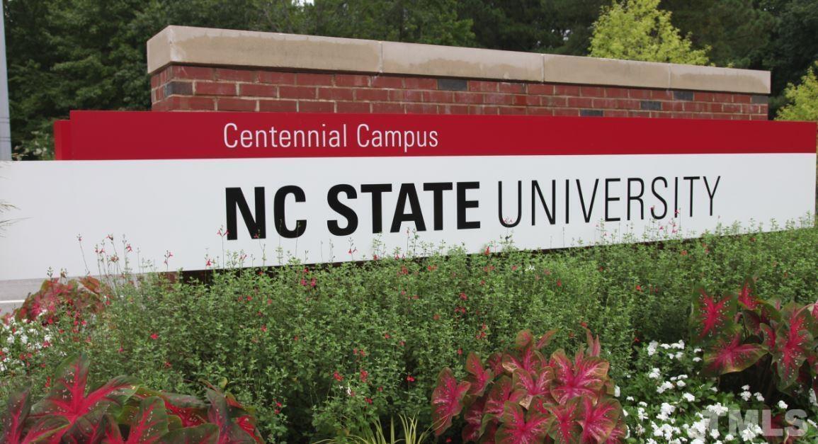 2441 Campus Shore Drive, Unit 309 Raleigh, NC 27606 - Photo 41 of 49 a sign that is sitting on a wooden wall