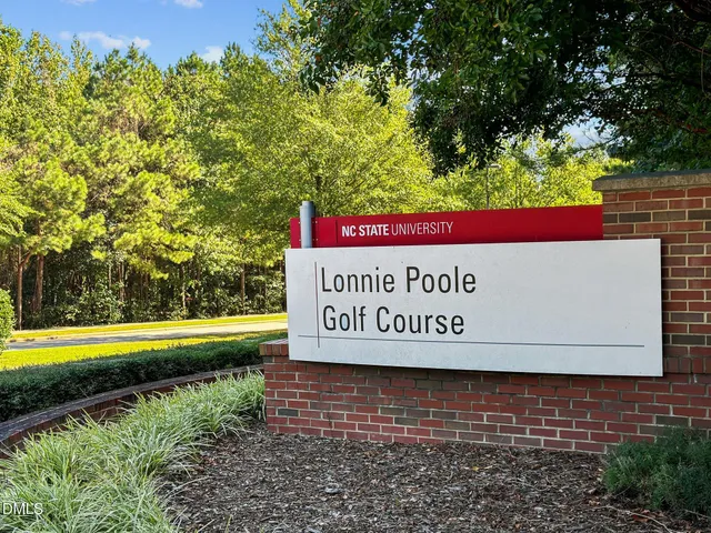 an aerial view of a house with a garden space and outdoor seating