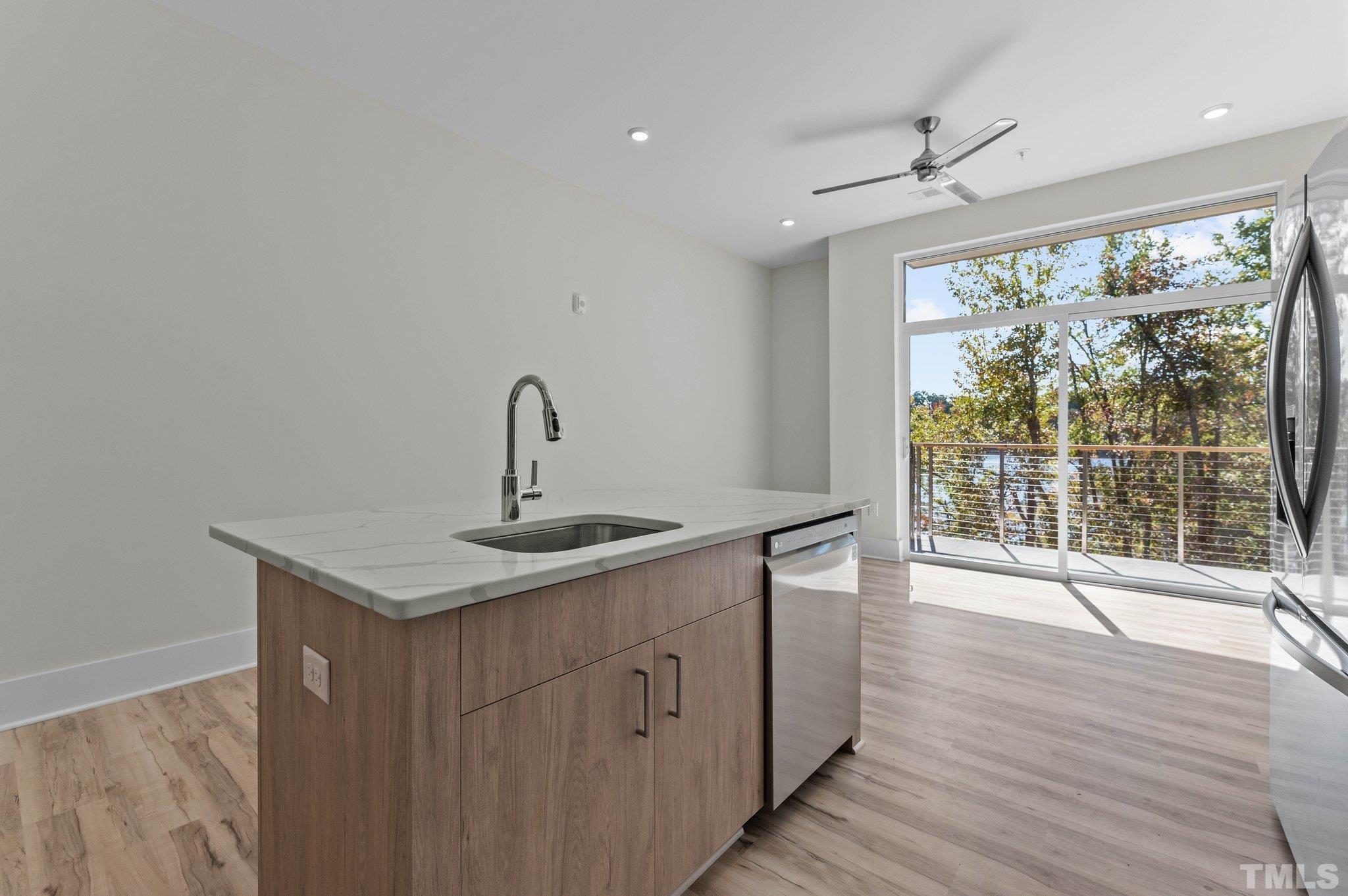 2441 Campus Shore Drive, Unit 309 Raleigh, NC 27606 - Photo 8 of 49 a kitchen with a sink and wooden floor