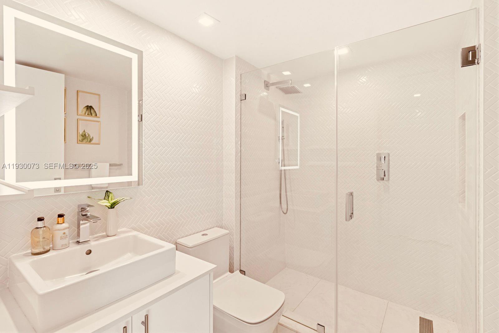 2127 Brickell Avenue, Unit 1505 Miami, FL 33129 - Photo 20 of 37 a bathroom with a sink toilet and shower